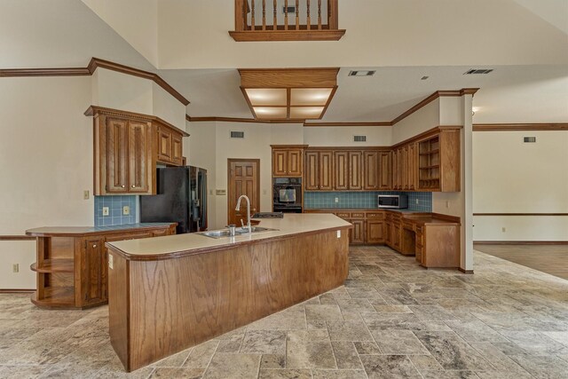 kitchen with open shelves, a sink, a high ceiling, brown cabinetry, and black appliances