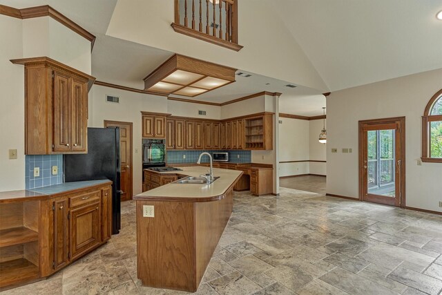 kitchen featuring open shelves, black appliances, a sink, brown cabinets, and a high ceiling