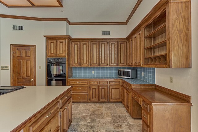 kitchen with stainless steel microwave, decorative backsplash, open shelves, light stone finish floors, and crown molding