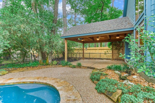 view of swimming pool with a ceiling fan, a patio area, and a fenced backyard