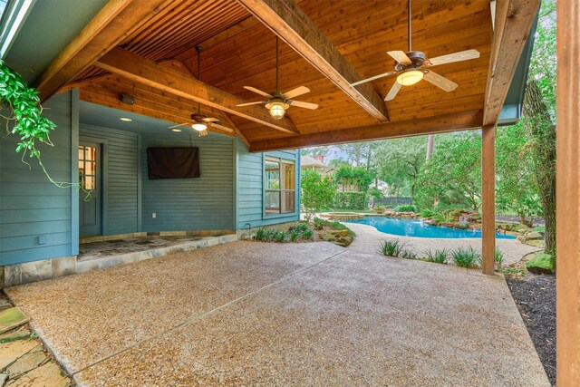 view of patio featuring ceiling fan and an outdoor pool