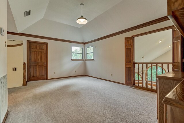 empty room with vaulted ceiling and carpet floors