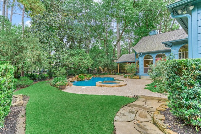 view of yard with an in-ground hot tub and a patio area
