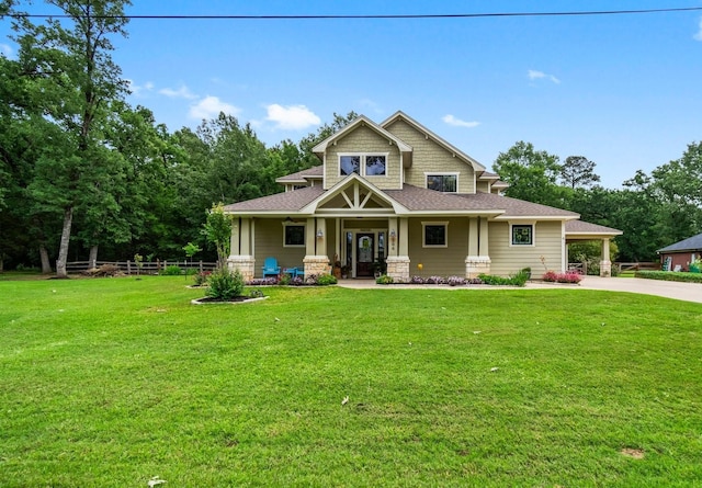 craftsman house with covered porch, driveway, roof with shingles, and a front lawn