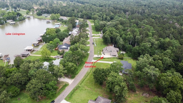 aerial view featuring a residential view, a water view, and a wooded view