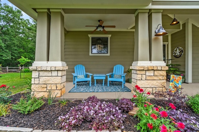 view of patio / terrace with a porch, ceiling fan, and fence