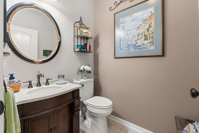 bathroom with tile patterned flooring, baseboards, toilet, and vanity