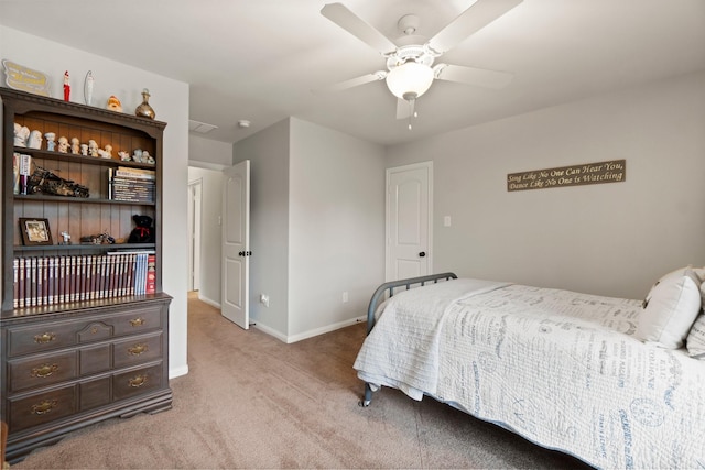 carpeted bedroom featuring baseboards and a ceiling fan