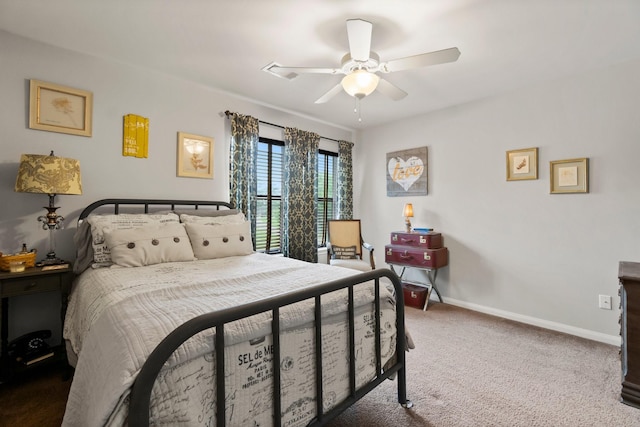 carpeted bedroom featuring baseboards and ceiling fan