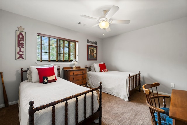 carpeted bedroom featuring baseboards, a ceiling fan, and visible vents