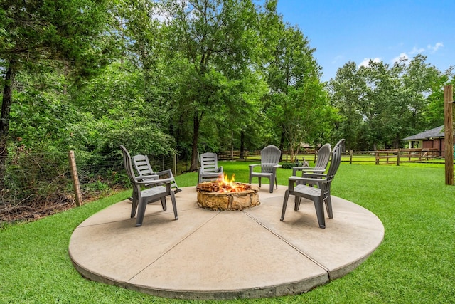 view of patio / terrace with fence and a fire pit
