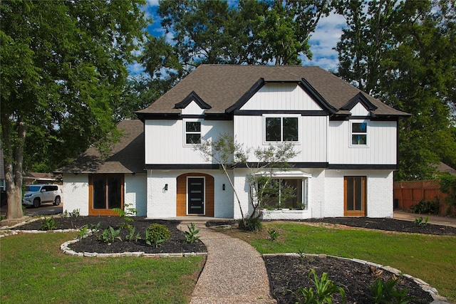 1719 Wagon Gap Trl, Houston, TX 77090 - modern inspired farmhouse with brick siding, roof with shingles, and a porch
