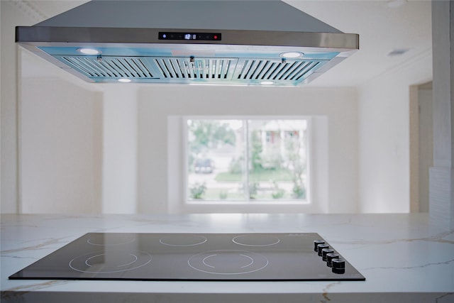 1719 Wagon Gap Trl, Houston, TX 77090 - kitchen view of range hood, light stone countertops, and black electric stovetop