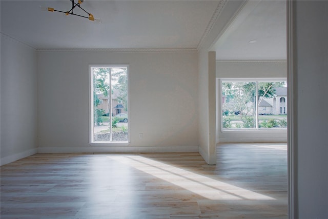 1719 Wagon Gap Trl, Houston, TX 77090 - unfurnished room featuring ornamental molding, plenty of natural light, a chandelier, wood finished floors, and baseboards