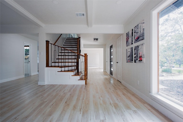 1719 Wagon Gap Trl, Houston, TX 77090 - hallway featuring light wood-style floors, healthy amount of natural light, stairs, beamed ceiling, and crown molding