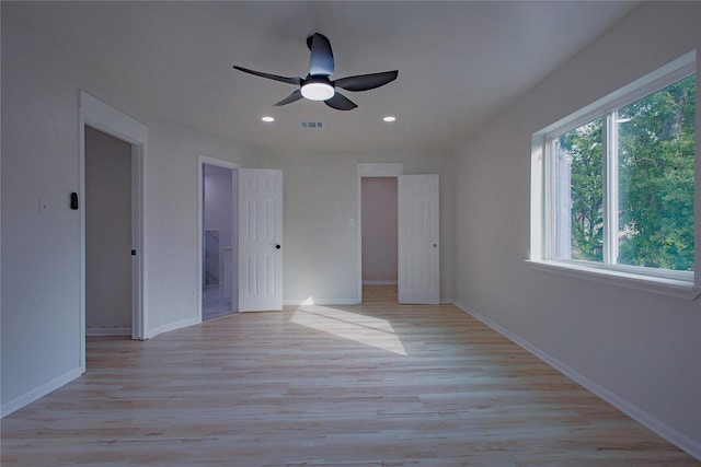 1719 Wagon Gap Trl, Houston, TX 77090 - unfurnished bedroom with multiple windows, recessed lighting, light wood-style floors, baseboards, and ceiling fan