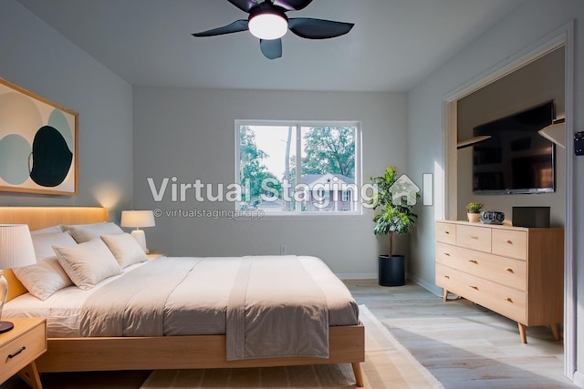 1719 Wagon Gap Trl, Houston, TX 77090 - bedroom featuring light wood-type flooring, a ceiling fan, and baseboards