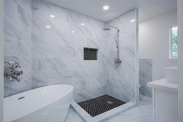 1719 Wagon Gap Trl, Houston, TX 77090 - bathroom featuring marble finish flooring, a tile shower, a freestanding tub, recessed lighting, and vanity