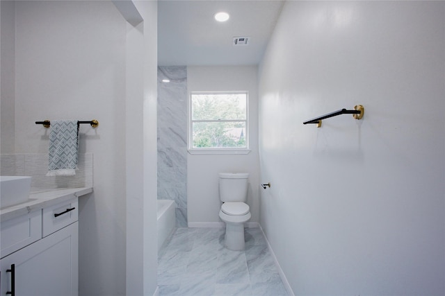 1719 Wagon Gap Trl, Houston, TX 77090 - bathroom with toilet, vanity, marble finish flooring, baseboards, and backsplash