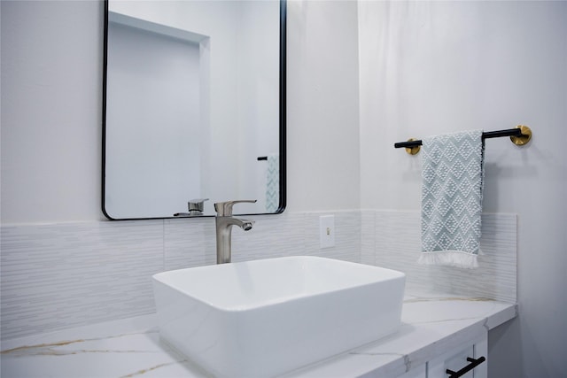 1719 Wagon Gap Trl, Houston, TX 77090 - bathroom featuring a sink, marble finish floors, tile walls, and wainscoting