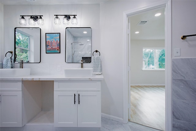 1719 Wagon Gap Trl, Houston, TX 77090 - bathroom featuring a shower, baseboards, double vanity, recessed lighting, and marble finish floors