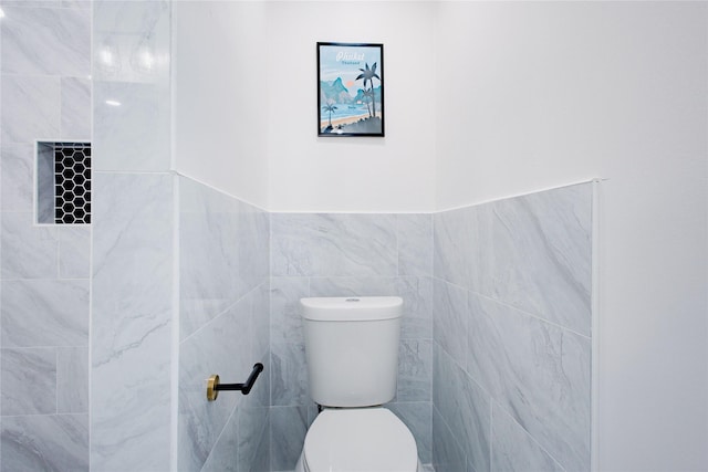1719 Wagon Gap Trl, Houston, TX 77090 - bathroom featuring tile walls and toilet