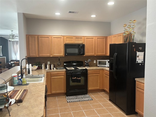16427 Kettlebrook Ln, Houston, TX 77049 - kitchen with visible vents, decorative backsplash, light countertops, a sink, and black appliances