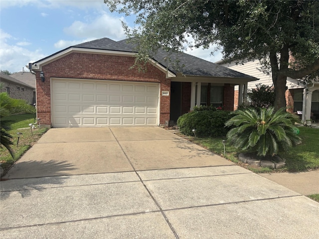 16427 Kettlebrook Ln, Houston, TX 77049 - ranch-style home with brick siding, a garage, driveway, and a shingled roof
