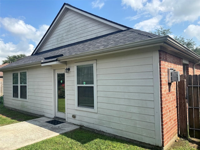 16427 Kettlebrook Ln, Houston, TX 77049 - exterior space featuring brick siding, roof with shingles, and fence