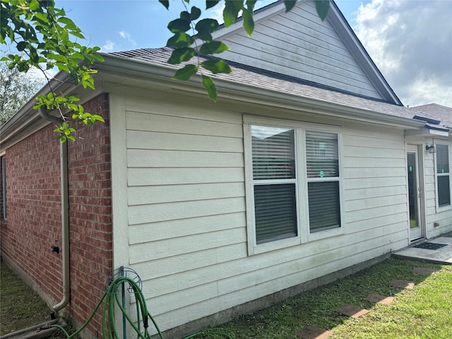 16427 Kettlebrook Ln, Houston, TX 77049 - view of side of home featuring brick siding and roof with shingles