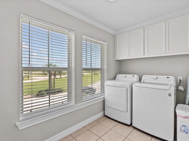 4035 Estuary Ct, Galveston, TX 77554 - laundry room with cabinet space, separate washer and dryer, light tile patterned floors, crown molding, and baseboards