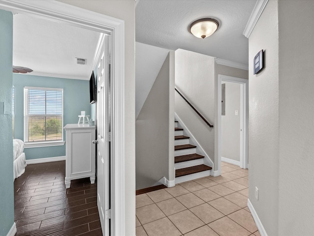 4035 Estuary Ct, Galveston, TX 77554 - stairway with crown molding, baseboards, and a textured ceiling