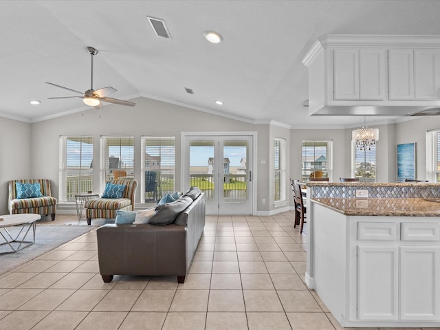 4035 Estuary Ct, Galveston, TX 77554 - living room featuring light tile patterned floors, ceiling fan, lofted ceiling, baseboards, and crown molding