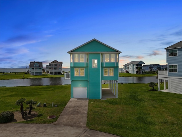 4035 Estuary Ct, Galveston, TX 77554 - view of outdoor structure with an attached garage, a water view, driveway, and a carport