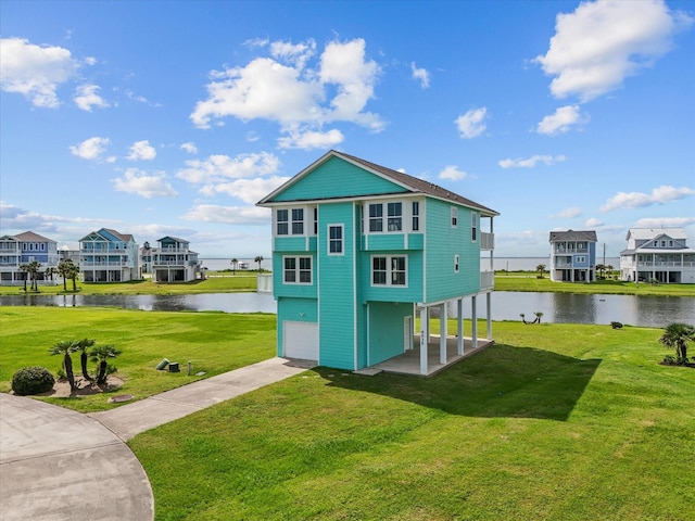 4035 Estuary Ct, Galveston, TX 77554 - view of outdoor structure featuring a water view, concrete driveway, and an attached garage