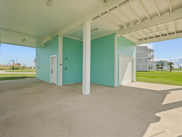 4035 Estuary Ct, Galveston, TX 77554 - view of patio / terrace with a carport, a garage, and driveway
