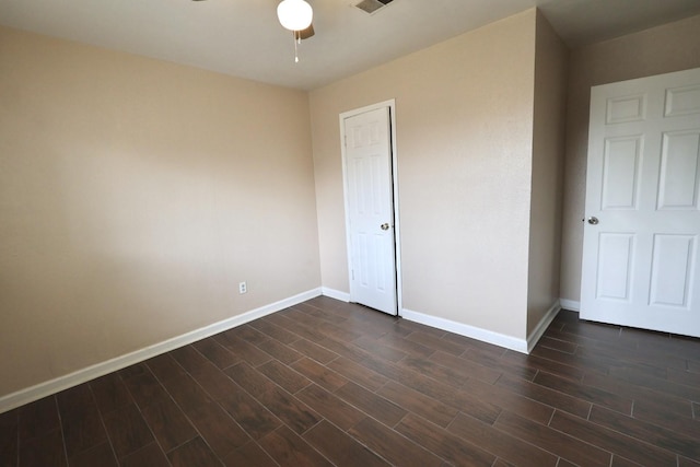 1217 E Brown Ln, Deer Park, TX 77536 - unfurnished bedroom featuring baseboards, dark wood-style floors, a ceiling fan, and a closet