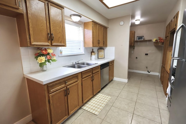 1217 E Brown Ln, Deer Park, TX 77536 - kitchen with a sink, stainless steel appliances, brown cabinets, decorative backsplash, and light countertops