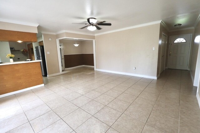 1217 E Brown Ln, Deer Park, TX 77536 - unfurnished living room featuring ceiling fan, light tile patterned flooring, baseboards, and crown molding