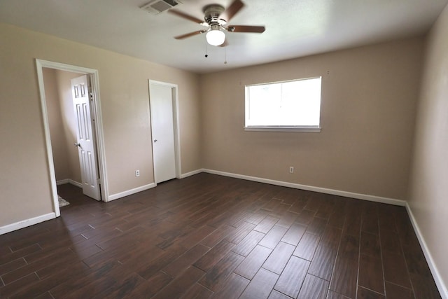 1217 E Brown Ln, Deer Park, TX 77536 - unfurnished bedroom featuring dark wood finished floors, baseboards, and ceiling fan