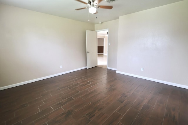 1217 E Brown Ln, Deer Park, TX 77536 - spare room featuring a ceiling fan, dark wood-type flooring, and baseboards