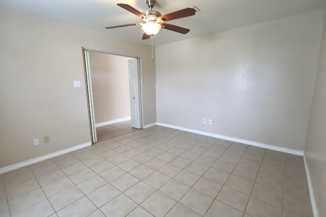 1217 E Brown Ln, Deer Park, TX 77536 - empty room featuring a ceiling fan, baseboards, and light tile patterned flooring
