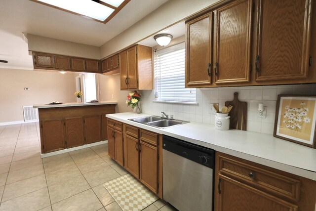 1217 E Brown Ln, Deer Park, TX 77536 - kitchen featuring dishwasher, a sink, light countertops, decorative backsplash, and a peninsula