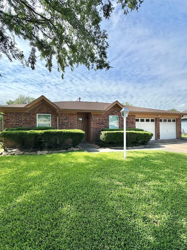 1217 E Brown Ln, Deer Park, TX 77536 - single story home featuring a front lawn, a garage, brick siding, and concrete driveway