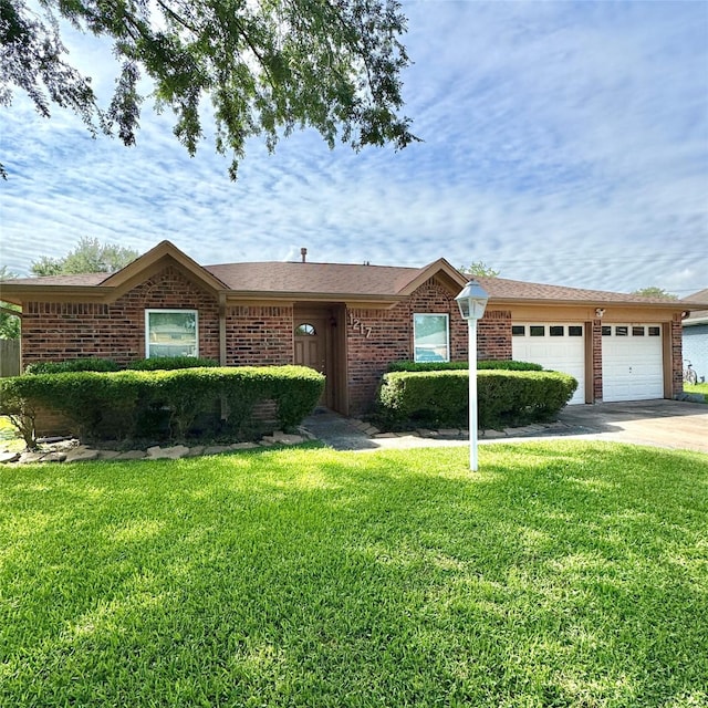 1217 E Brown Ln, Deer Park, TX 77536 - single story home featuring a garage, a front lawn, concrete driveway, and brick siding