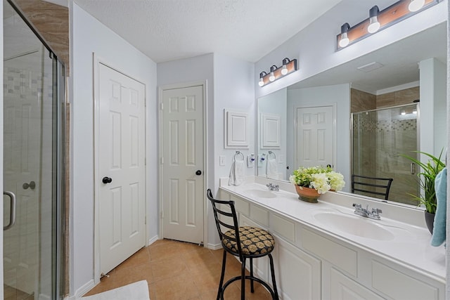 13935 Pueblo Run, Cypress, TX 77429 - full bathroom featuring a sink, tile patterned floors, a stall shower, and double vanity