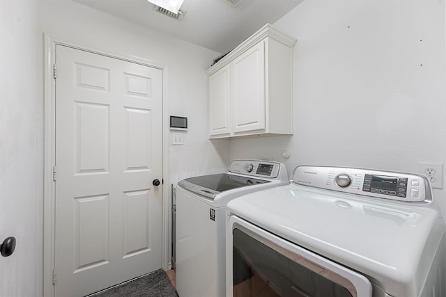 13935 Pueblo Run, Cypress, TX 77429 - washroom featuring visible vents, cabinet space, and washer and clothes dryer