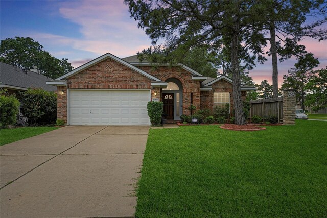 13935 Pueblo Run, Cypress, TX 77429 - view of front of home with a lawn, a garage, driveway, and brick siding