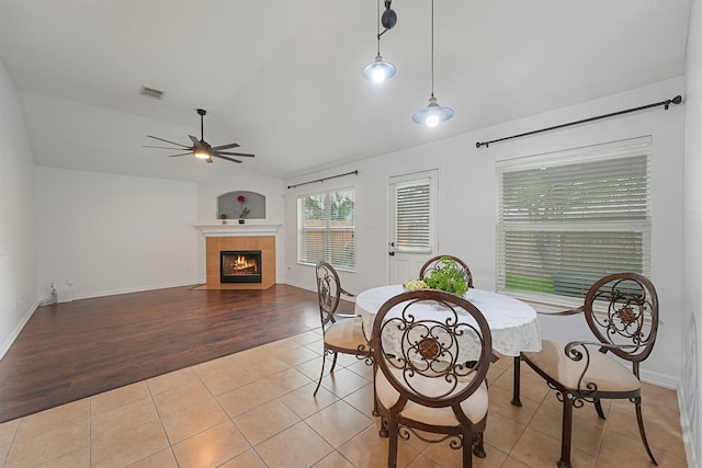 13935 Pueblo Run, Cypress, TX 77429 - tiled dining area with ceiling fan, a tiled fireplace, baseboards, lofted ceiling, and visible vents