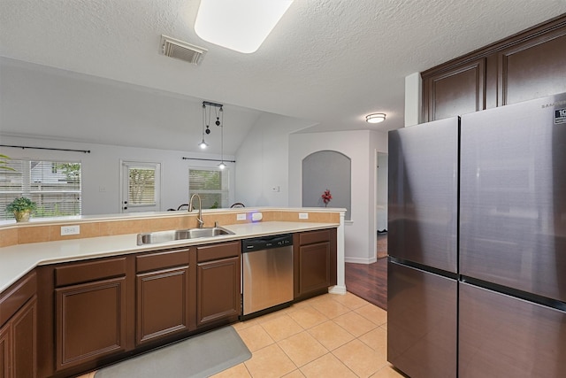 13935 Pueblo Run, Cypress, TX 77429 - kitchen with appliances with stainless steel finishes, a sink, light countertops, light tile patterned floors, and visible vents